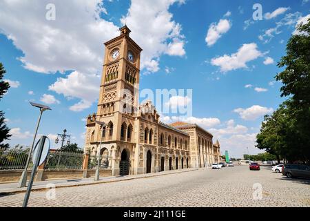 Clock tower of Toledo railway station exterior on blue cloudy sky background, station has been declared Property of Cultural Interest and classified a Stock Photo