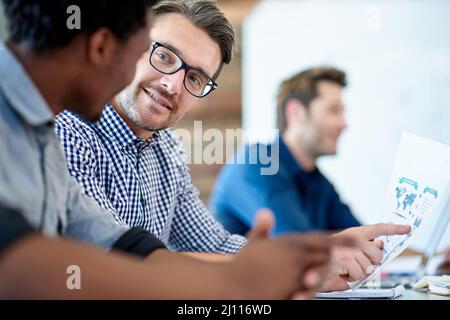 Sharing dynamic ideas. Two male professionals having a positive conversation in a meeting room. Stock Photo