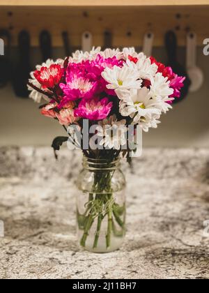 Vertical shot of the transvaal daisy bouquet placed on the table in a glass vase Stock Photo