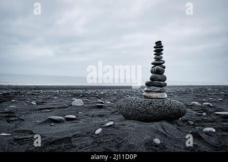 small stone tower on a black beach in Iceland Stock Photo