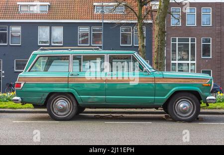 Haarlem, North Holland, The Netherlands, 20.03.2022, Side view of classic Jeep Wagoneer 1976 in green colour Stock Photo