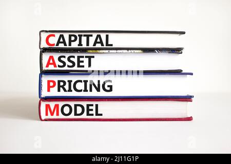 CAPM capital asset pricing model symbol. Concept words CAPM capital asset pricing model on books on a beautiful white background. Business CAPM capita Stock Photo