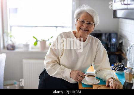 Portrait of smiling senior woman at home Stock Photo