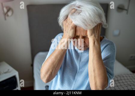 Senior woman covering face with her hands Stock Photo
