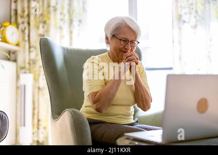 Senior woman using laptop at home Stock Photo
