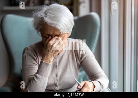 Senior woman suffering from a headache Stock Photo