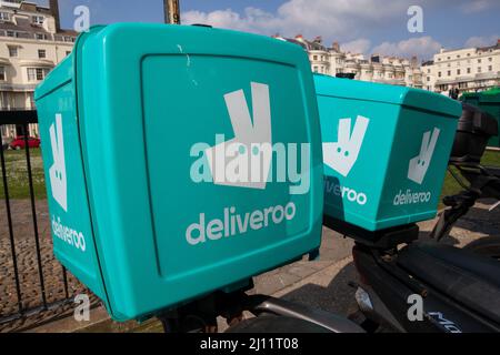Deliveroo courier boxes on the rear of motorbikes in Brighton, East Sussex Stock Photo