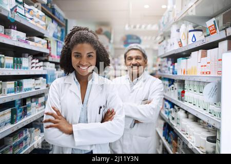 Ready to give you quality service. Cropped portrait of two pharmacists standing together with their arms crossed in a pharmacy. Stock Photo
