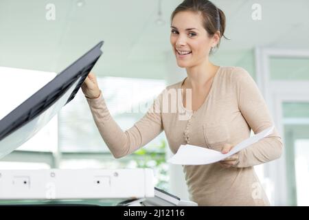 cheerful happy woman man using a copy machine Stock Photo