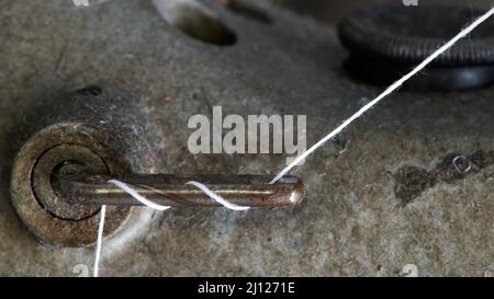 Industrial sewing machine's part where the thread goes around Stock Photo