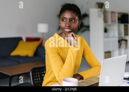 Thoughtful young black working from home Stock Photo