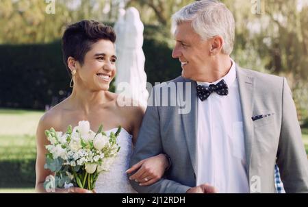 I know this is your dream come true. Cropped shot of an affectionate mature father smiling at his daughter while walking her down the while on her Stock Photo