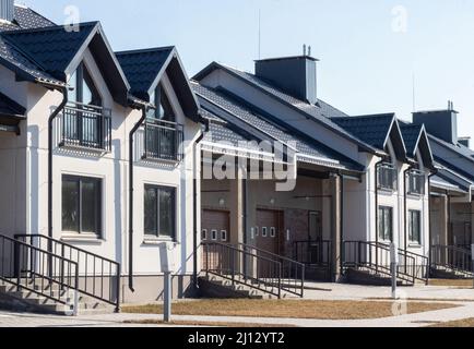 Exterior view of a modern townhouse. The concept of outdoor buildings of multi-apartment residential townhouses Stock Photo