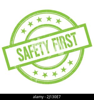 SAFETY FIRST text written on green round vintage rubber stamp. Stock Photo