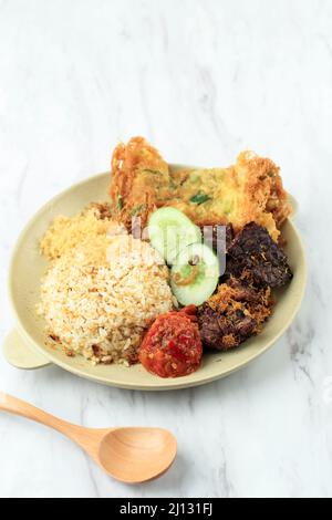 Nasi Campur Buk Madura with Paru (Cow Lung) and Serundeng (Shredded Coconut). Close Up Stock Photo
