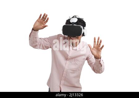 Young peruvian man laughing using virtual reality headset, isolated. Stock Photo