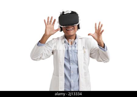 Young peruvian male scientific using virtual reality headset, isolated. Stock Photo