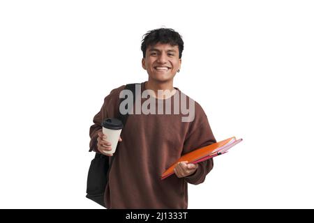 Young peruvian student smiling, holds folders, backpack and a coffee, isolated. Stock Photo