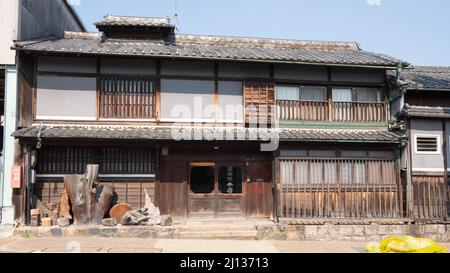 A traditional wooden house with rice paper window screens (shoji) along a downtown street in Nara Stock Photo