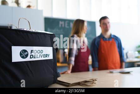 Take away boxes with lunch prepared for delivery in thermo bag in restaurant.