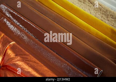 Leather samples in shiny brown and yellow colors texture background Stock Photo