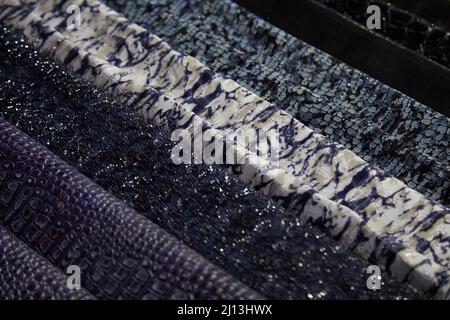 Reptile leather samples in dark and mottled colors texture background Stock Photo
