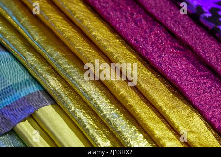 Metallic leather samples in yellow, golden and pink colors texture background Stock Photo