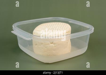 typical Brazilian Minas cheese from Minas Gerais in transparent plastic bowl Stock Photo