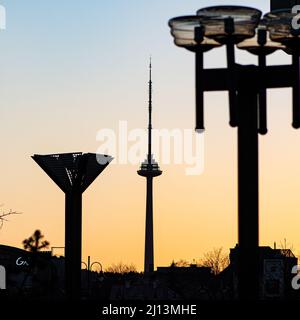 Silhouette of Vilnius TV tower and city street lamps with sunset or sunrise sky on background Stock Photo