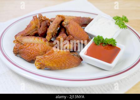 Spicy Deep Fried Buffalo Wings Served with Hot Sauce and Blue Cheese Dressing Stock Photo