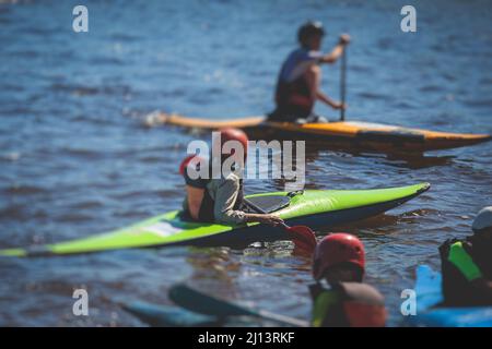 Kids learn kayaking, canoeing whitewater training in the lake river, children practicing paddling, yound kayakers in a summer camp Stock Photo