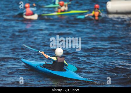 Kids learn kayaking, canoeing whitewater training in the lake river, children practicing paddling, young kayakers in a summer camp Stock Photo