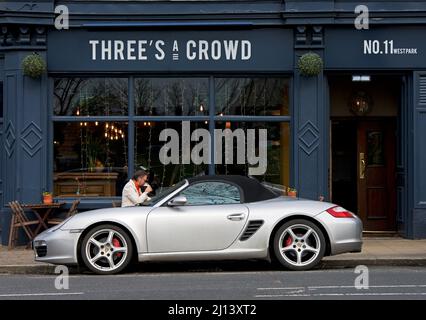Porsche Boxter parked outside Three's a Crowd, West Park, Harrogate, North Yorkshire, England UK Stock Photo