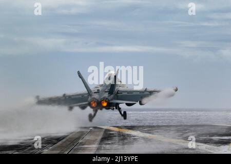 Philippine Sea, United States. 20 March, 2022. A U.S. Navy EA-18G Growler fighter jet, attached to the Wizards of Electronic Attack Squadron 133, launches off the flight deck of the Nimitz-class aircraft carrier USS Abraham Lincoln during routine operations, March 15, 2022 in the Philippine Sea.  Credit: MCS Julia Brockman/Planetpix/Alamy Live News Stock Photo
