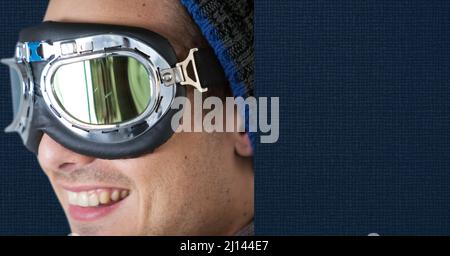 Close up of caucasian man wearing ski goggles against copy space on blue background Stock Photo