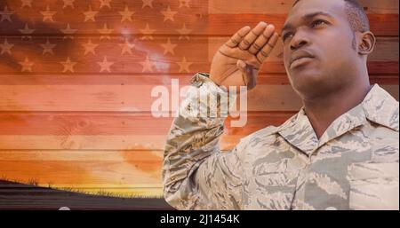 Digital composite of Soldier saluting against brown background with ...