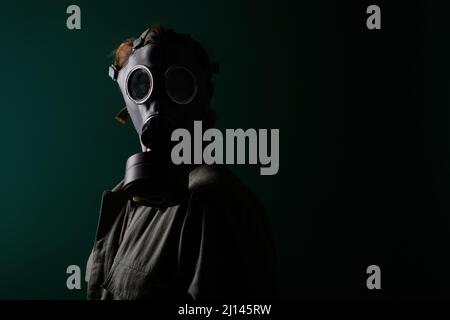 Photo of a military man in a gas mask, apocalypse, nuclear weapons, atomic explosion of a station, chemical and nuclear weapons protection. Girl in a Stock Photo
