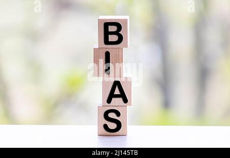 Bias - word from wooden blocks with letters, personal opinions prejudice bias concept, random letters around, white background Stock Photo
