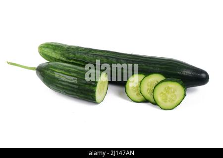 green whole cucumber, and cucumber slices side by side, isolated on a white background. Stock Photo