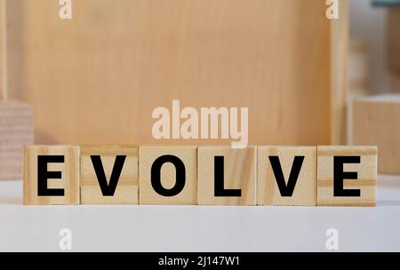 EVOLVE word made with building blocks isolated on white. Stock Photo