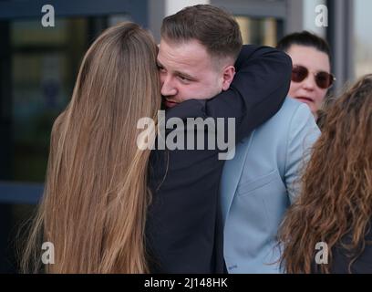 Daroch McKeague, the brother of Corrie McKeague, embraces his partner Leah McElrea outside Suffolk Coroner's Court, Ipswich, Suffolk, following a verdict at the inquest into his death. The inquest jury recorded in a narrative conclusion that Mr McKeague died at approximately 4.20am in Bury St Edmunds as a result of 'compression asphyxia in association with multiple injuries'. Mr McKeague vanished on a night out in Bury St Edmunds on September 24 2016. Picture date: Tuesday March 22, 2022. Stock Photo