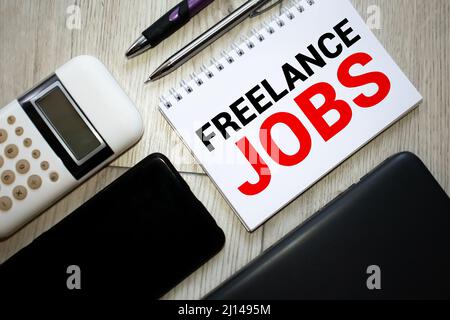 Word writing text FREELANCE JOBS. Business concept for situation in which an employee works mainly from home Note paper taped to black computer screen Stock Photo