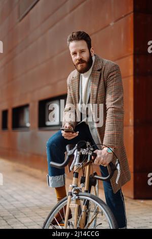 Young man using smartphone with mobile app. Creative businessman in a modern business area. Stock Photo