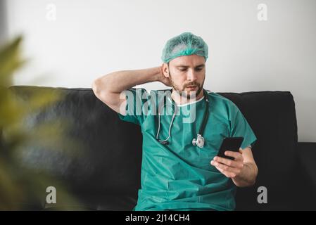 Doctor using phone in the resting room Stock Photo