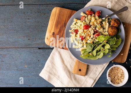 Overhead view of fresh italian food served in plate on serving board over wooden table Stock Photo
