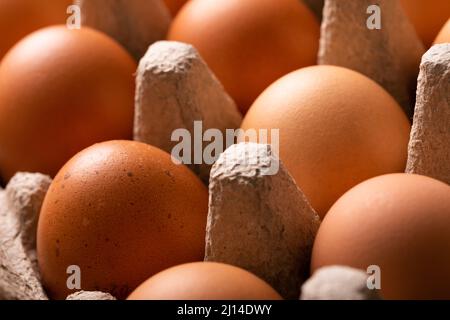 Full frame close-up shot of fresh brown eggs on carton Stock Photo