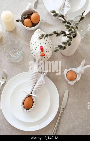 Easter table setting with Easter eggs and willow in vase. Top view. Stock Photo