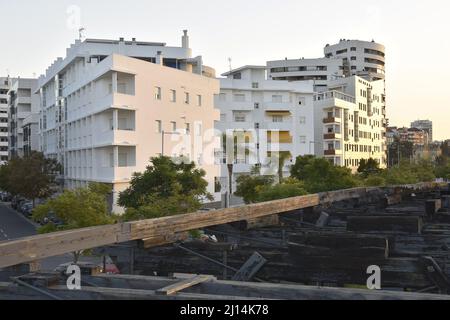 Modern residential blocks and remains of old wooden pier in Huelva Andalusia Spain. Stock Photo