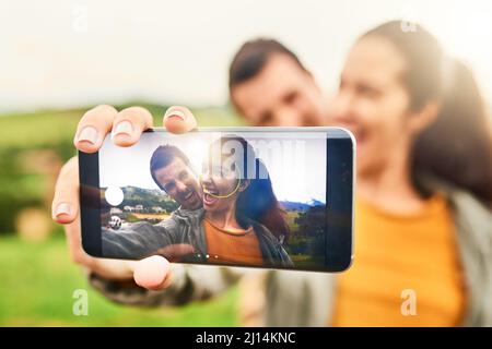 True love can be seen in pictures. Cropped shot of a loving couple taking a selfie outdoors. Stock Photo