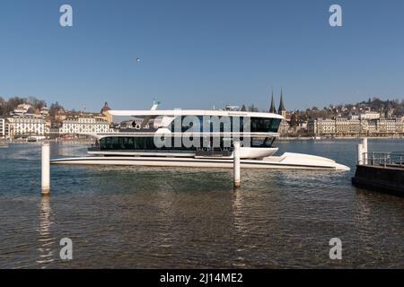 Lucerne, Switzerland, March 10, 2022 Ferry boat is taking tourists across the lake of Lucerne on a sunny day Stock Photo